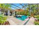 Enclosed patio featuring comfortable seating, lush landscaping, and an inviting outdoor ambiance at 617 Islebay Dr, Apollo Beach, FL 33572