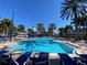 Community pool area with palm trees and plenty of seating for residents to enjoy at 617 Islebay Dr, Apollo Beach, FL 33572