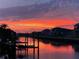 Dramatic waterfront sunset view, reflecting in the canal and silhouetting the neighborhood at 617 Islebay Dr, Apollo Beach, FL 33572