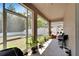 Spacious screened porch with plenty of plants and seating at 13951 Caden Glen Dr, Hudson, FL 34669