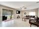 Spacious living room with a large sectional sofa and sliding glass doors leading to the patio at 13951 Caden Glen Dr, Hudson, FL 34669
