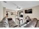 Open living room with a large sectional sofa and views of the kitchen at 13951 Caden Glen Dr, Hudson, FL 34669