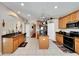 Spacious kitchen with island, granite countertops, and wood cabinets at 13951 Caden Glen Dr, Hudson, FL 34669