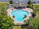 Community pool with lounge chairs and umbrellas at 13951 Caden Glen Dr, Hudson, FL 34669