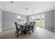 Bright dining room features a dark wood table with gray chairs and access to the backyard at 5805 8Th Avenue W Dr, Bradenton, FL 34209