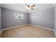 Bright bedroom with ceiling fan and wood-look flooring at 5805 8Th Avenue W Dr, Bradenton, FL 34209