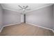 Simple bedroom with ceiling fan and light gray walls at 5805 8Th Avenue W Dr, Bradenton, FL 34209
