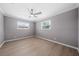 Simple bedroom with ceiling fan and light gray walls at 5805 8Th Avenue W Dr, Bradenton, FL 34209