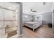 Main bedroom with walk-in shower and light wood platform bed at 5805 8Th Avenue W Dr, Bradenton, FL 34209