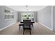 Simple dining room with light grey walls and wood flooring at 5805 8Th Avenue W Dr, Bradenton, FL 34209
