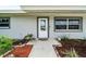 White front door entrance with landscaping at 5805 8Th Avenue W Dr, Bradenton, FL 34209