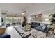 Bright living room with comfy sectional sofa, large windows, and view to patio at 15641 Aurora Lake Cir, Wimauma, FL 33598