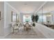 Elegant dining room with chandelier, oval table, and mirrored wall at 15641 Aurora Lake Cir, Wimauma, FL 33598