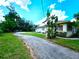 Side view of the house showing the driveway and landscaping at 14141 11Th St, Dade City, FL 33525