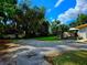 Large backyard with grassy area and partial view of home at 14141 11Th St, Dade City, FL 33525