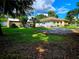 View of back of house, detached shed, and grassy yard at 14141 11Th St, Dade City, FL 33525