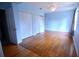 Bedroom with hardwood floors, light-blue walls, and double closets at 14141 11Th St, Dade City, FL 33525