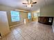 Bedroom with tile floors, dresser, and large windows at 14141 11Th St, Dade City, FL 33525