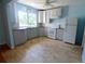 Updated kitchen featuring gray cabinets and tile floors at 14141 11Th St, Dade City, FL 33525