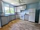 Updated kitchen featuring gray cabinets and tile floors at 14141 11Th St, Dade City, FL 33525