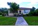 Brick ranch home with a walkway and landscaped yard at 14141 11Th St, Dade City, FL 33525
