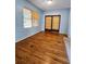 Light-blue living room with hardwood floors and sliding glass doors at 14141 11Th St, Dade City, FL 33525