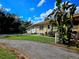 Ranch style home with spacious yard, driveway, and mature landscaping at 14141 11Th St, Dade City, FL 33525