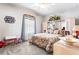 Spacious bedroom with a floral comforter and built-in shelving at 33668 Willow Point Ct, Wesley Chapel, FL 33545