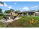 Spacious backyard featuring fire pit and green grass at 15635 Bear Creek Dr, Tampa, FL 33624