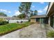 Large backyard with grass and a patio featuring an outdoor firepit area at 15635 Bear Creek Dr, Tampa, FL 33624