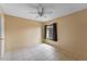 Bedroom featuring tile flooring, a bright window, and a ceiling fan at 15635 Bear Creek Dr, Tampa, FL 33624