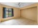 Bedroom featuring tile flooring, ceiling fan, and a bright window at 15635 Bear Creek Dr, Tampa, FL 33624
