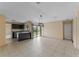 Open dining room with tile flooring, kitchen view, and a sliding glass door to the backyard at 15635 Bear Creek Dr, Tampa, FL 33624