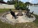 Inviting backyard fire pit area with seating, ideal for gatherings and outdoor relaxation at 15635 Bear Creek Dr, Tampa, FL 33624