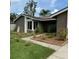 Beautifully landscaped front yard with a walkway leading to the charming single-story home at 15635 Bear Creek Dr, Tampa, FL 33624