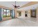 Bright living room with tile flooring, large windows and sliding glass doors leading to the backyard at 15635 Bear Creek Dr, Tampa, FL 33624