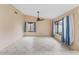 Spacious living room with tile floors, large windows, and a ceiling fan at 15635 Bear Creek Dr, Tampa, FL 33624