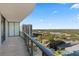 Balcony with glass railing overlooking city skyline and green landscape at 2912 Santiago St # 1201, Tampa, FL 33629