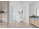 A bright bathroom with soaking tub, glass shower and modern vanity provide a spa-like space at 2912 Santiago St # 1201, Tampa, FL 33629