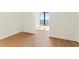 This bedroom's hardwood floors, base trim and expansive glass window provide a cozy space with natural light at 2912 Santiago St # 1201, Tampa, FL 33629
