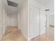 Bright hallway with recessed lighting, neutral walls, and sleek tile flooring leading to various rooms at 2912 Santiago St # 1201, Tampa, FL 33629