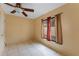 Bedroom with tile floors, window, and ceiling fan at 15635 Bear Creek Dr, Tampa, FL 33624