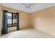 Bedroom with window, tile floors and ceiling fan at 15635 Bear Creek Dr, Tampa, FL 33624