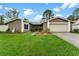 Single-story home with attached garage and well-maintained lawn at 15635 Bear Creek Dr, Tampa, FL 33624