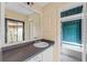 Bathroom with vanity, tub, and teal tile at 15635 Bear Creek Dr, Tampa, FL 33624