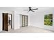 Spacious bedroom with ceiling fan and sliding closet doors at 1105 Conant Ave, Safety Harbor, FL 34695