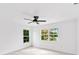 Bright bedroom with ceiling fan and large windows at 1105 Conant Ave, Safety Harbor, FL 34695