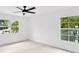 Well-lit bedroom with ceiling fan and two windows at 1105 Conant Ave, Safety Harbor, FL 34695