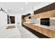 Modern kitchen with wood and dark cabinetry, marble countertops, and stainless steel appliances at 1105 Conant Ave, Safety Harbor, FL 34695