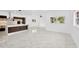 Open concept living area with kitchen island and large windows at 1105 Conant Ave, Safety Harbor, FL 34695